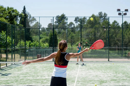 Two beginners playing padel on a padel court