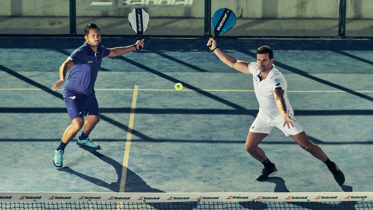 Two men playing padel on a court with babolat lamborghini padel rackets