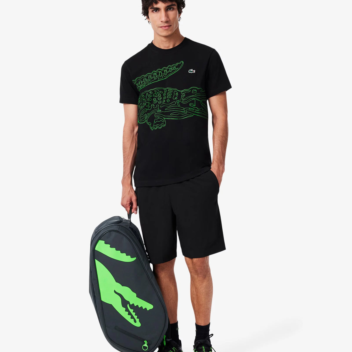 Lacoste L-Paletero black and green padel bag, player carrying the bag