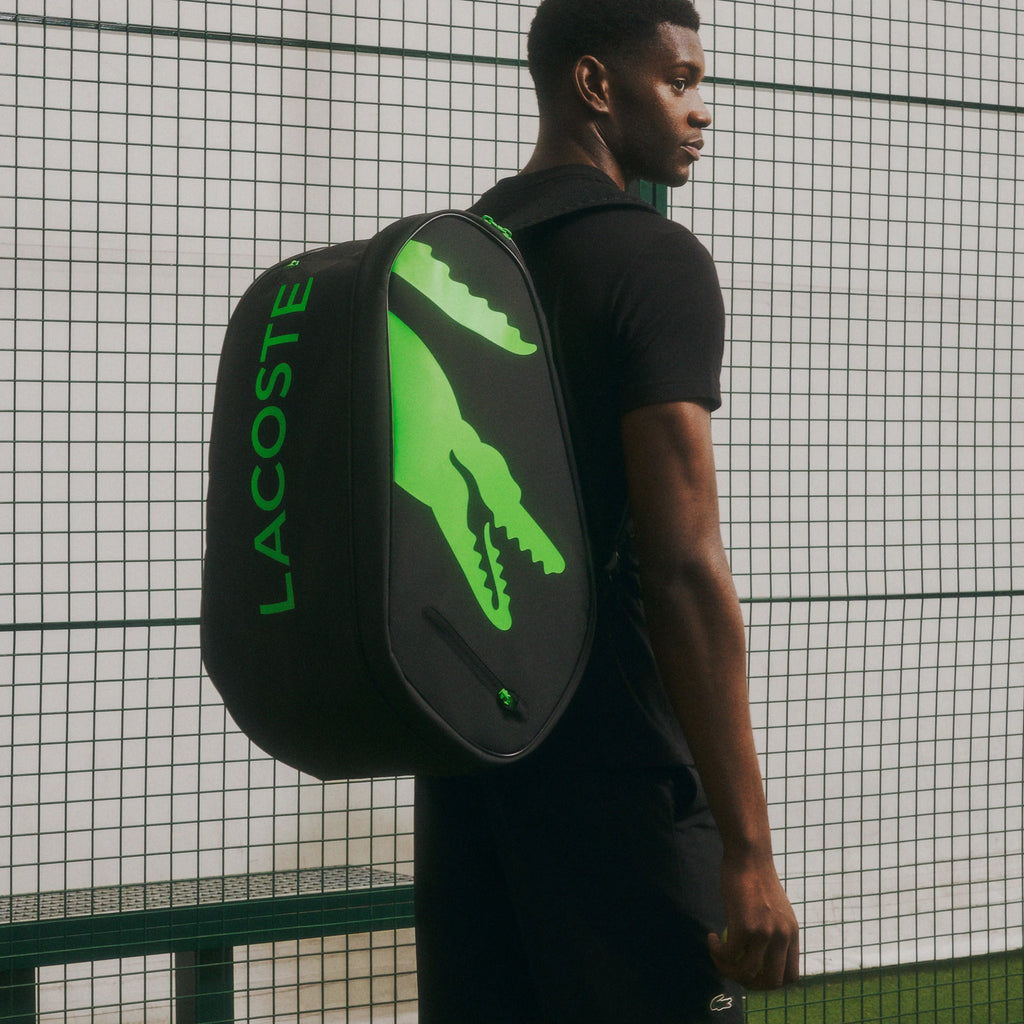 Lacoste L-Paletero black and green padel bag, on-court carry view
