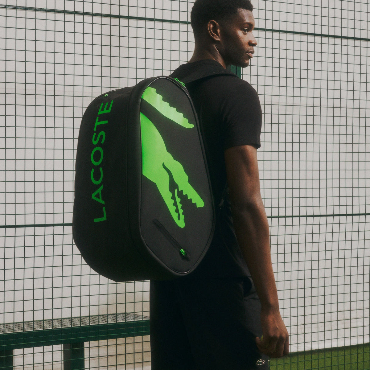 Lacoste L-Paletero black and green padel bag, on-court carry view